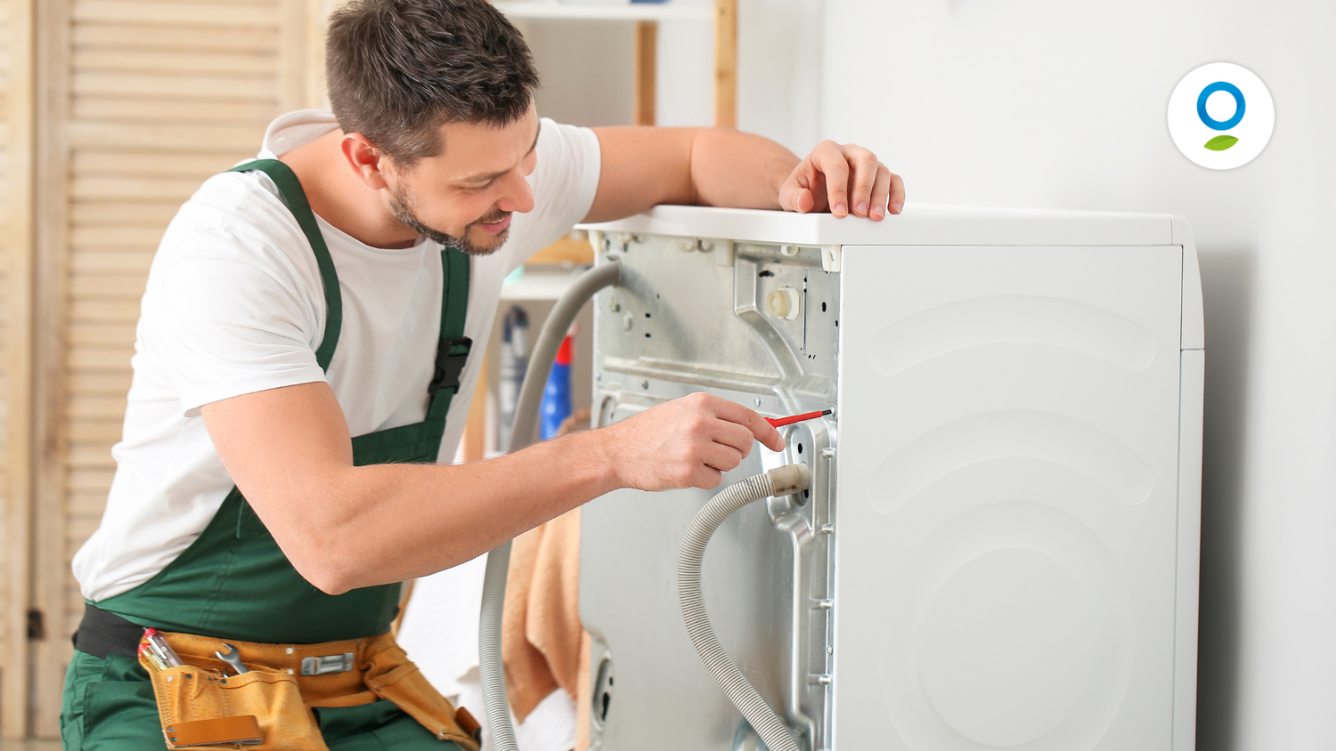 Uomo che sistema una lavatrice con il cacciavite